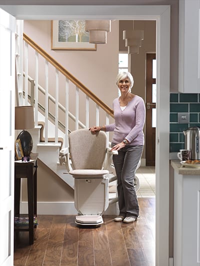 Starla Stairlift curved unfolded at the base of stair banisters.